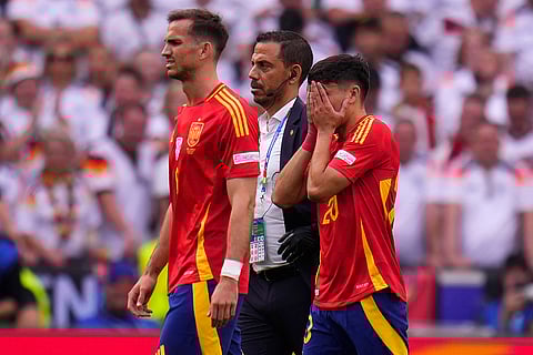 Spain's Pedri walks off the pitch after suffering an injury